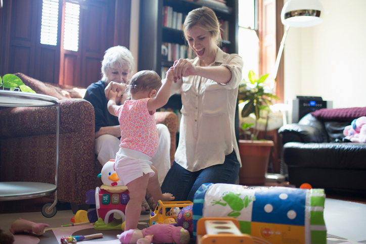 Mother helping daughter learn to walk